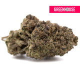 A dense sugar thca hemp flower bud with green and brown hues covered in trichomes showcasing greenhouse thca and terpene profile