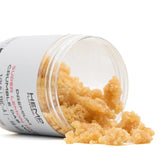 Yellow granular Super Lemon Haze THCA Crumble Wax spilling from a clear jar