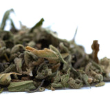 A pile of dried greenish-brown turtle taffy thca trim leaves with fuzzy texture showcasing cannabinoid content
