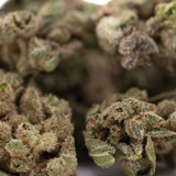 Lush dense turtle taffy thca flower smalls with fine trichomes and orange pistils hemp flower textured surface