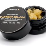 Black container of Watermelon 95% THCa Crumble Dab Wax revealing yellow hemp flower crumble inside