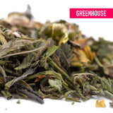 A pile of dried green and yellow zkittlez cross greenhouse thca trim leaves with tropical citrus candy-sweet flavor