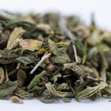 Dried green mint leaves with fuzzy texture and brown edges in zonkers greenhouse thca trim for cookies n cream fans