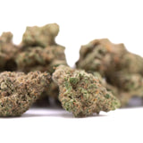 Green and brown dense textured cannabis buds of Zonkers THCa greenhouse smalls with cookies n cream and lemon tree notes