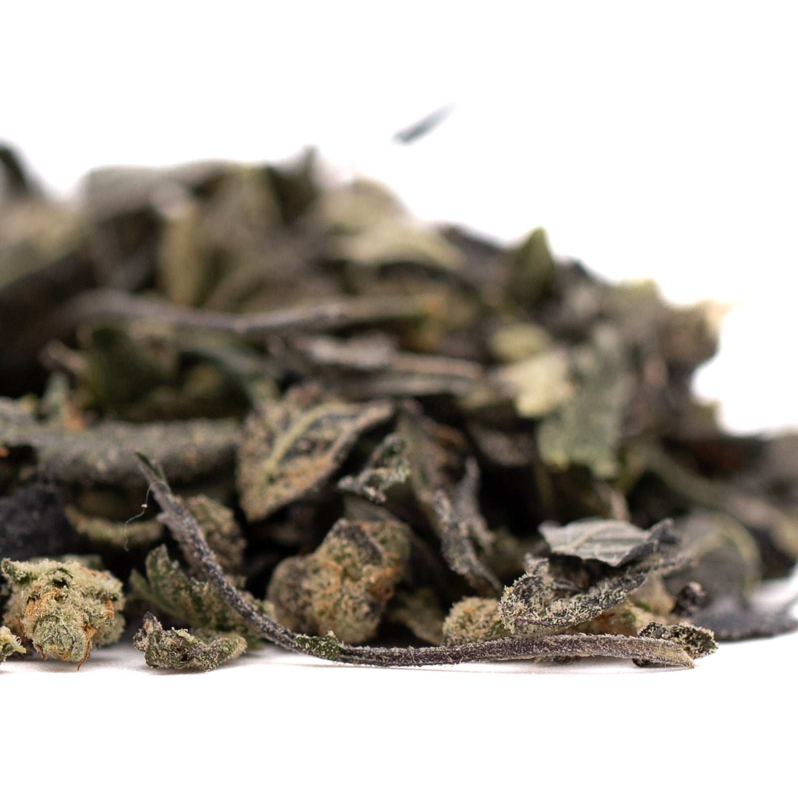 Astroboy Indoor Trim with dried green tea leaves and light brown nuggets for euphoric head effects