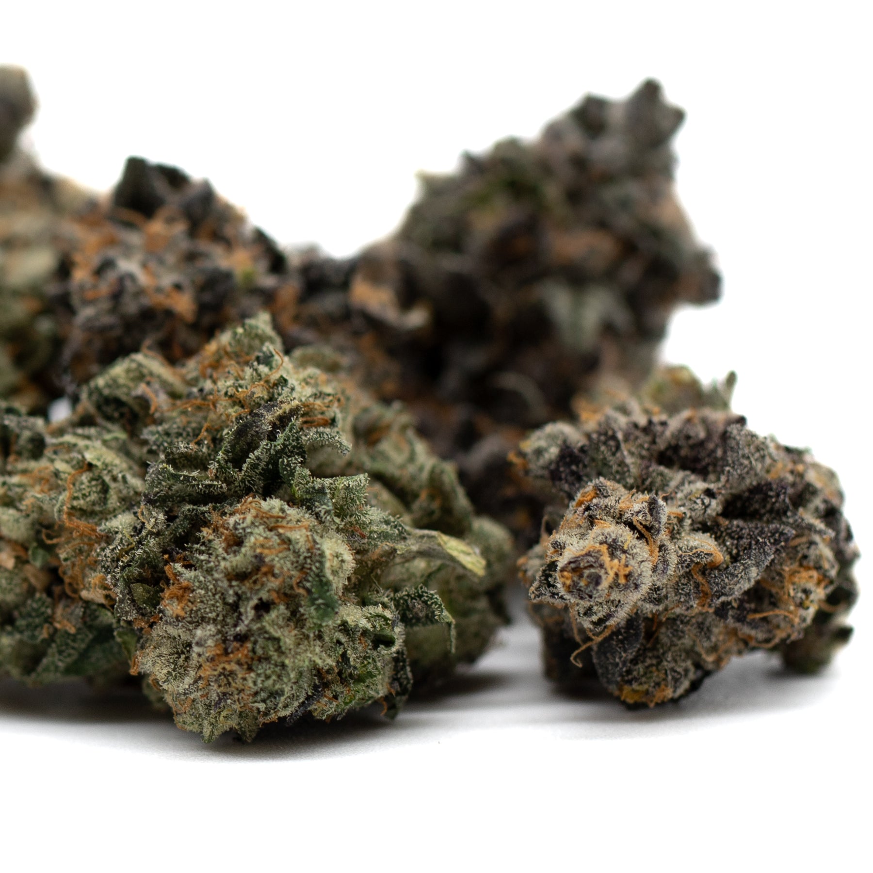 Dried cannabis buds with green purple and orange hues from Chunky Monkey Indoor THCa Flower