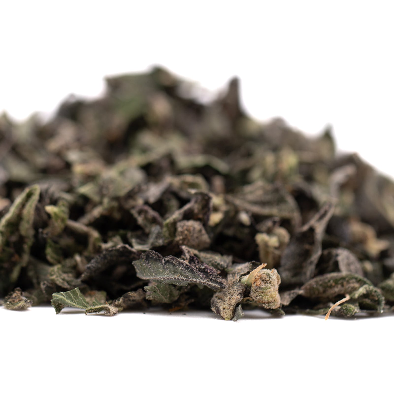 Dried dark green indoor THCA trim with small buds for solo hash plant or spicy lemon hash products