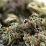 Purple-green Mega Gummie Bearz THCa flower smalls with trichomes