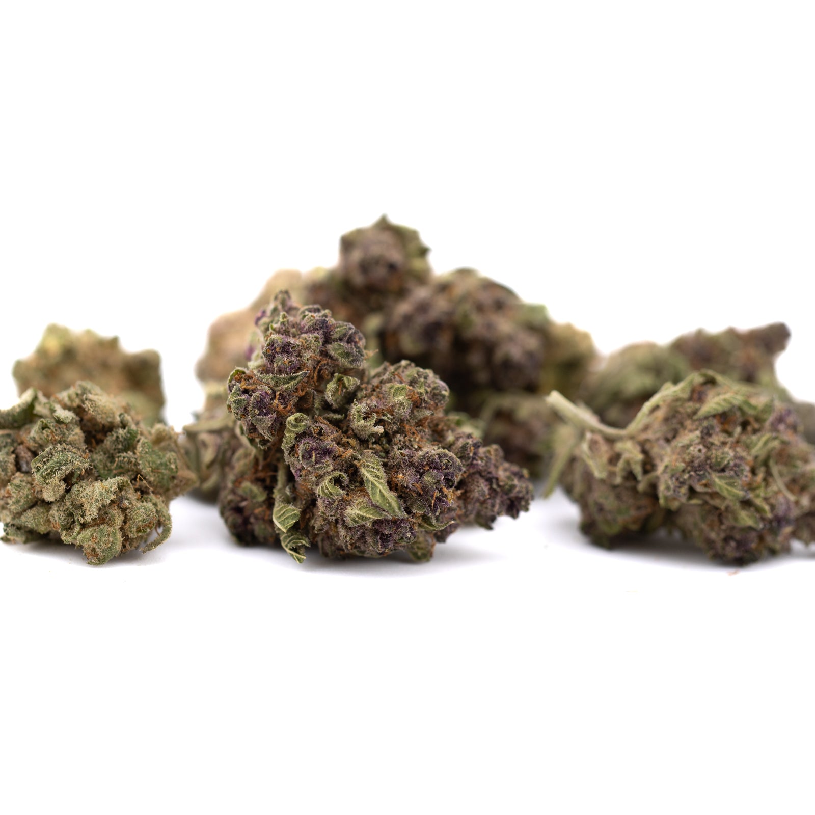 Pineapple Express Indoor THCa Flower Smalls with dried cannabis buds and purple hues