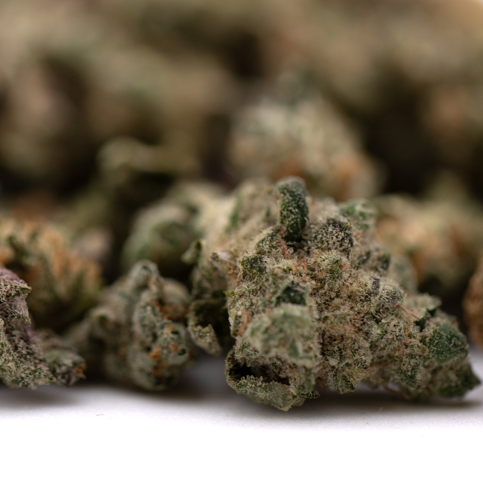 Close-up of Sour Candy Indoor THCa Flower Smalls with prominent trichomes