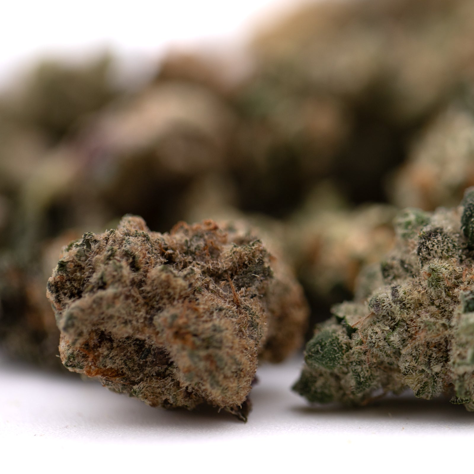 Pile of Sour Candy Indoor THCa Flower Smalls showing premium indoor THCa flower buds