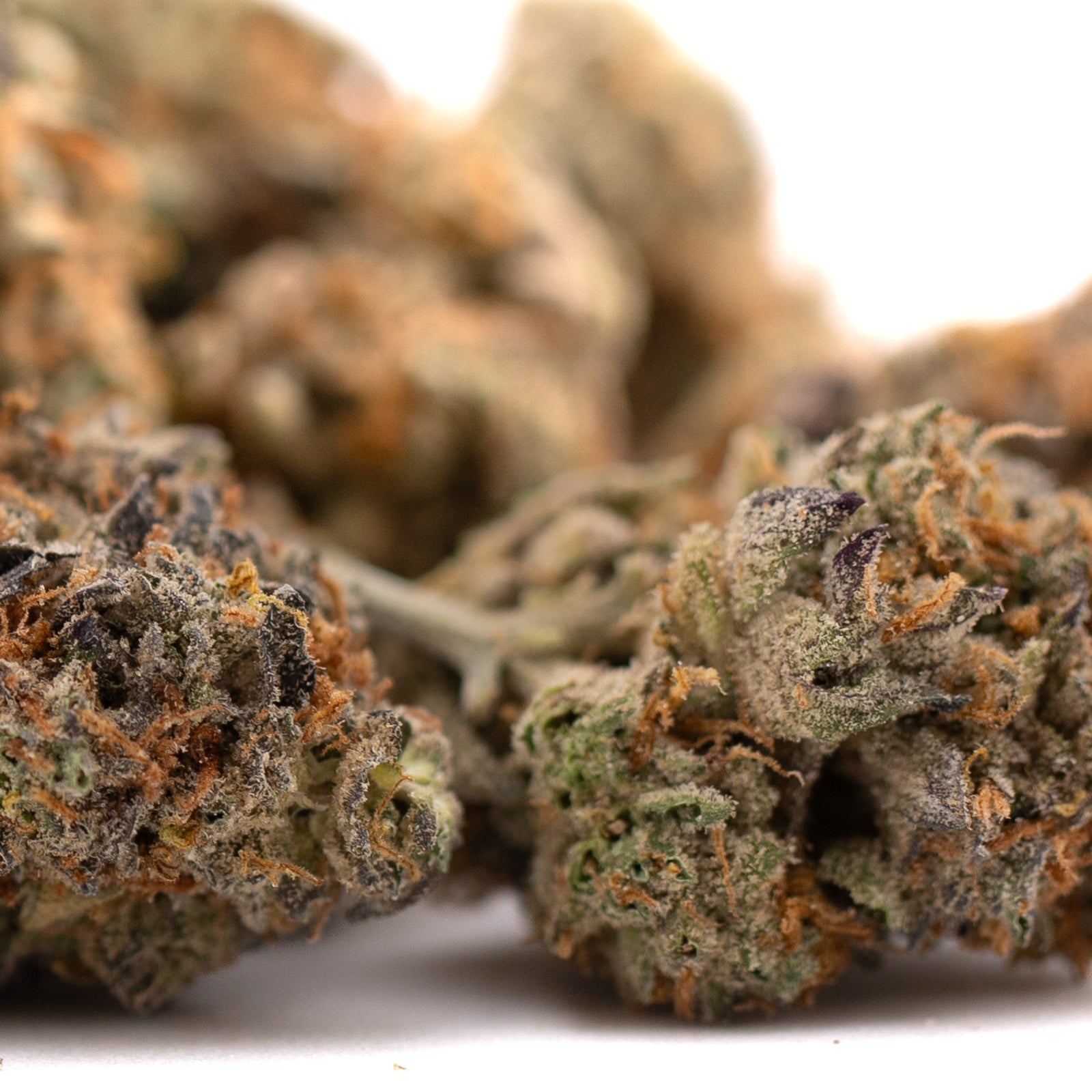 Southern Peaches THCa Flower with dried cannabis buds, orange hairs, frosty trichomes