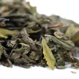 Dried white tea leaves with silvery frosty texture and muted green hues in after dark 2 greenhouse thca trim for sunset sherbet