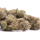 A dense green and orange-hued alaskan huckleberry diesel indoor cannabis bud with a textured surface
