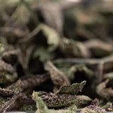 Banana Kush THCa trim: green leafy hemp flower buds with white trichomes