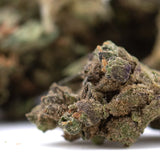 Banana og’s full-term thca hemp flower smalls showing dense resinous bud with green and purple hues and fine trichomes