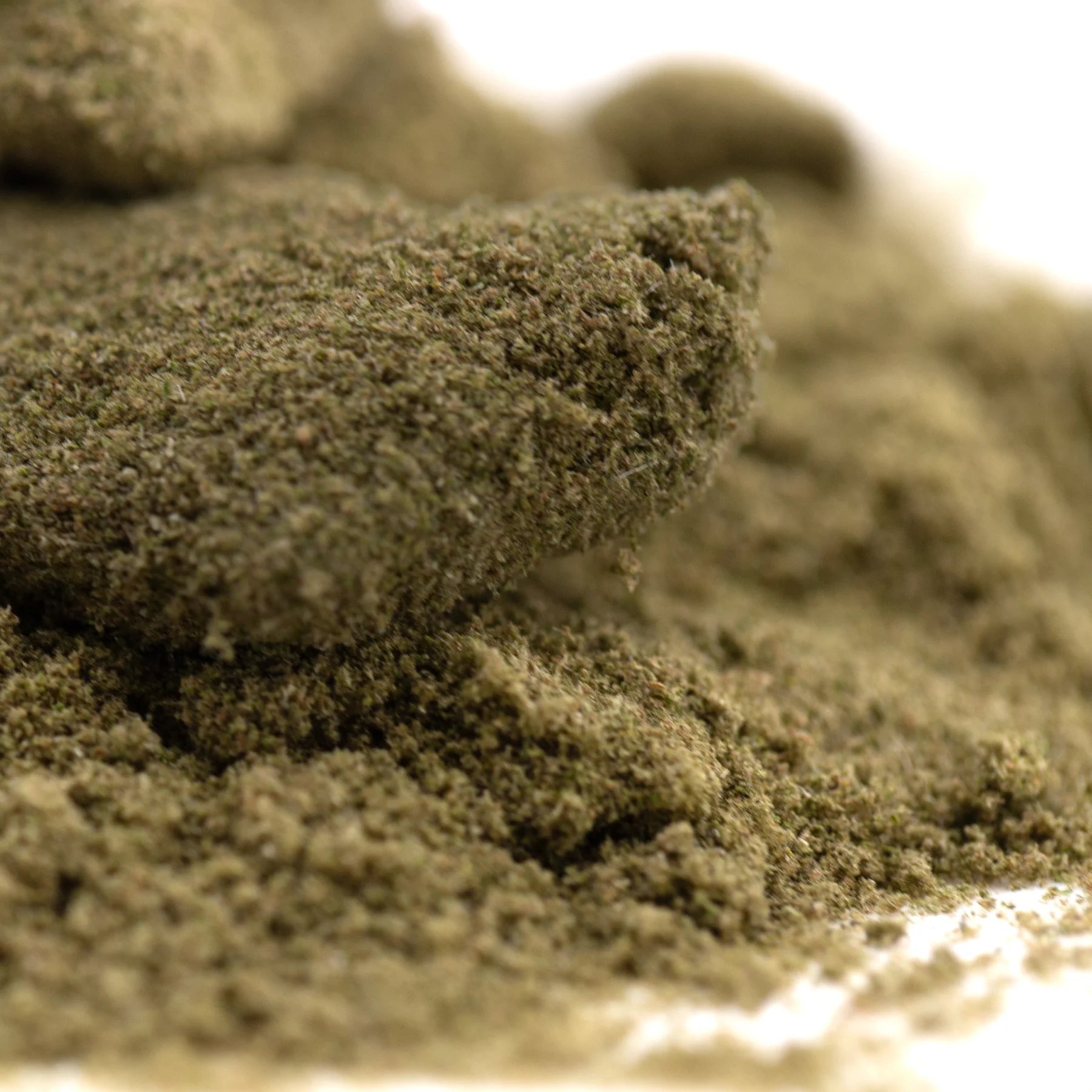 A mound of coarse green thca kief with a tropical character from the legendary banana strain for wholesale use