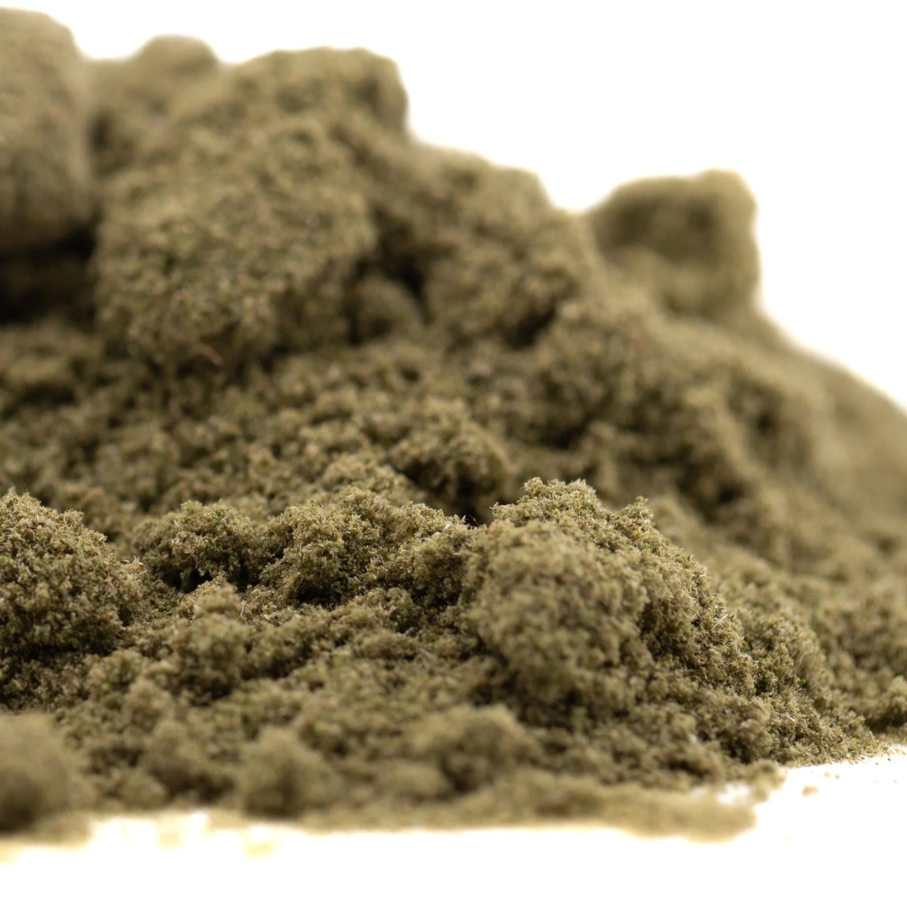 A mound of fine olive green thca kief with a tropical character from banana og full term wholesale batch