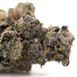 Berry Blast THCa hemp flower bud with green-purple hues and trichomes