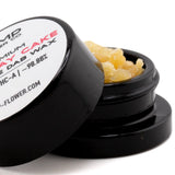 Black plastic container holding yellowish birthday cake thca crumble wax 5 gram hemp flower concentrate