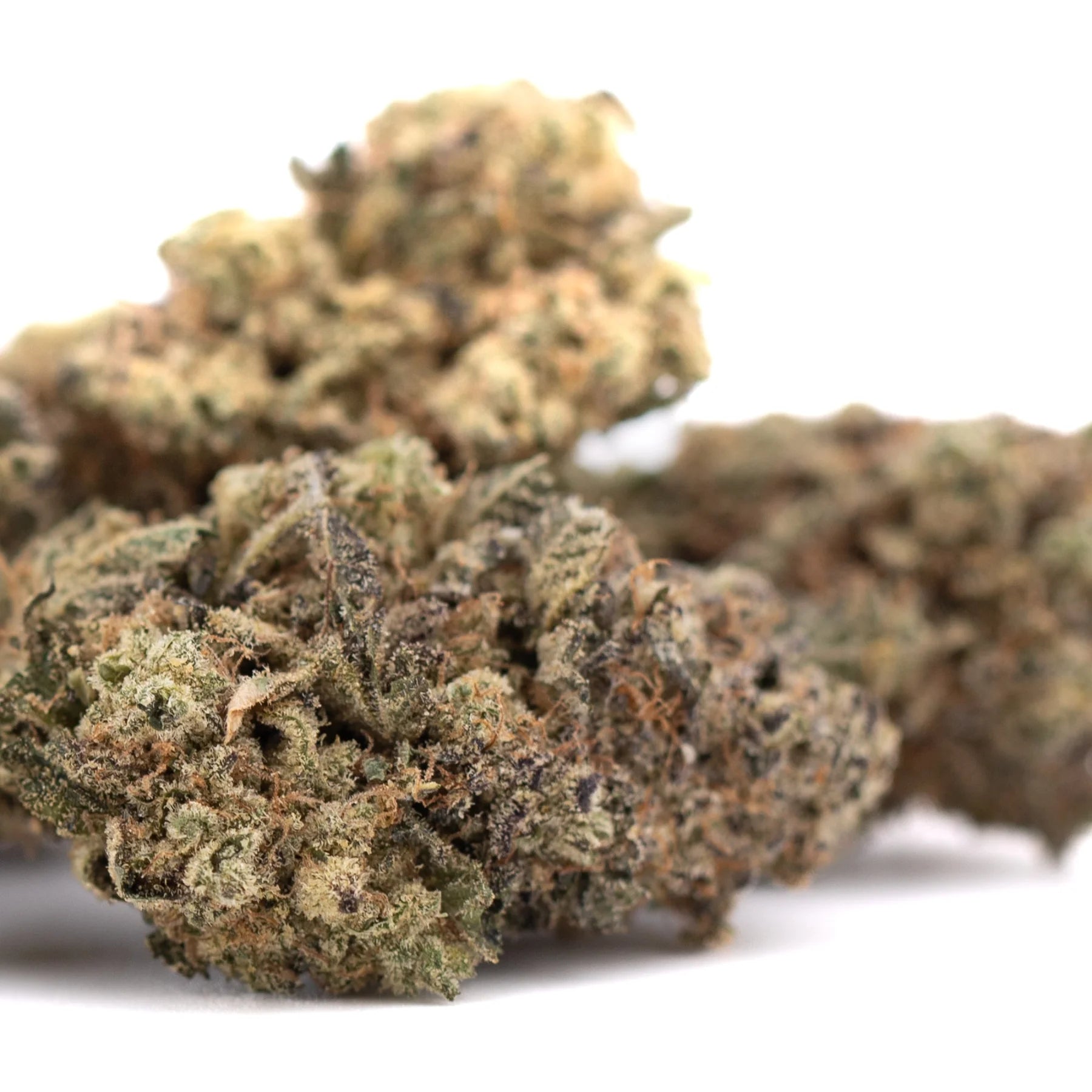 Mature black amber indoor thca flower buds with dense trichomes and green brown amber hues on textured surface