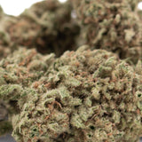A dense green legendary blue dream thca hemp flower with fuzzy texture and orange pistils for mainstream accessibility