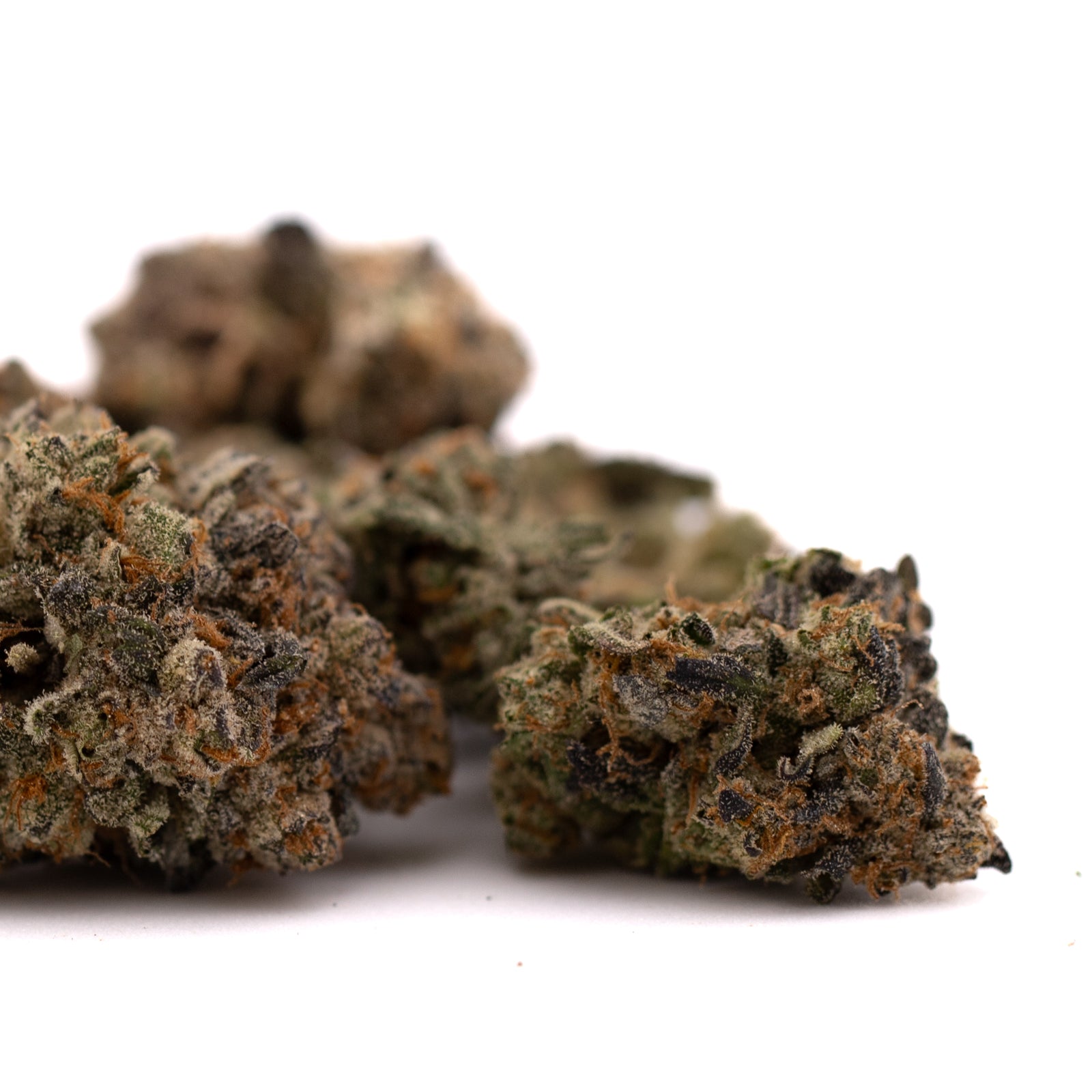 Blue Heron THCa flower with dried cannabis buds, trichomes, and orange hairs