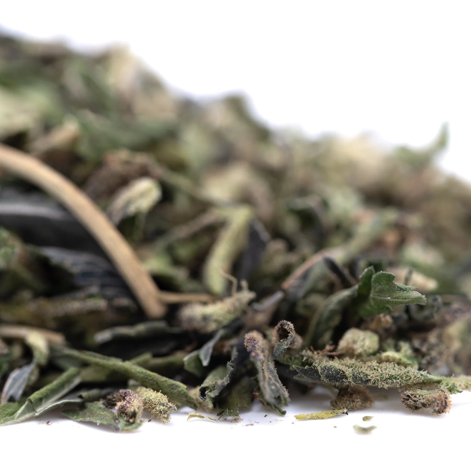 A pile of dried greenish brown blue sugar’s greenhouse thca trim with stems and small buds for sugar cookies use