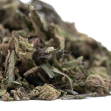 A pile of blueberry muffin thca trim hemp flower buds with green brown and earthy tones for wholesale use