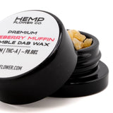 Black cylindrical container of hemp flower premium ryeberry muffin dab wax with amber blueberry muffin thca crumble wax
