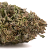 A dense textured green and brown bolor tartz thca hemp flower covered in fine trichomes from tartz greenhouse