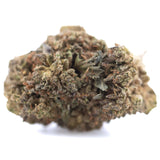 A dense textured bubba kush cbd full-term hemp flower bud with green and brown hues for relaxation and wellness