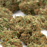 Green and orange-hued bubble gum cbd hemp flower full-term smalls with a frosty textured surface from indiana bubble