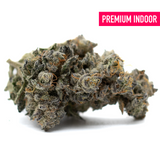 Premium indoor THCa flower Butter OG with dense frosty trichomes and orange pistils