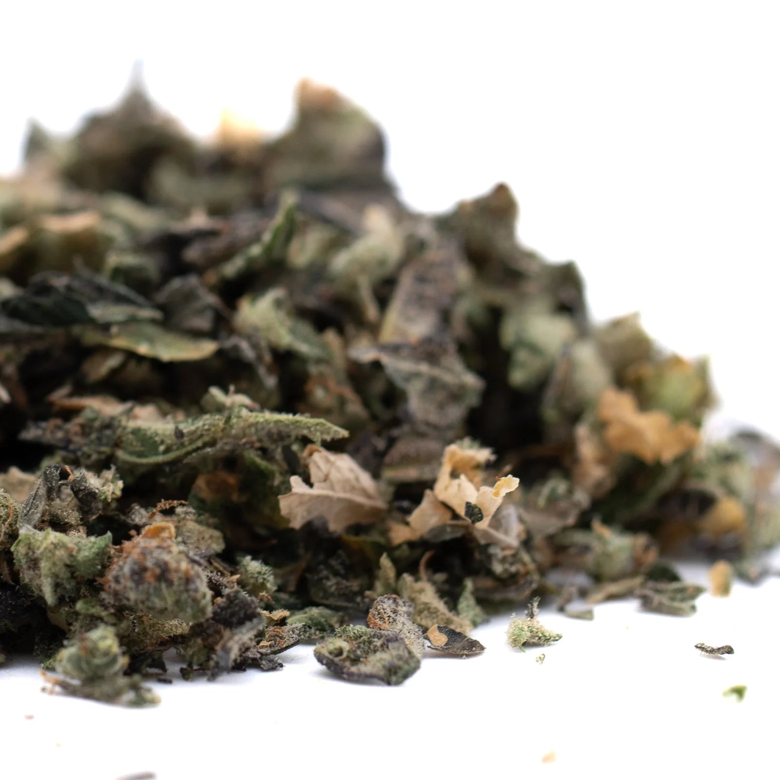Dried green and light brown herbs from Butter OG Indoor Thca Trim Wholesale 1lb