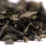 Dried green tea leaves with Girl Scout Cookies, THCA trim, and hemp flower properties