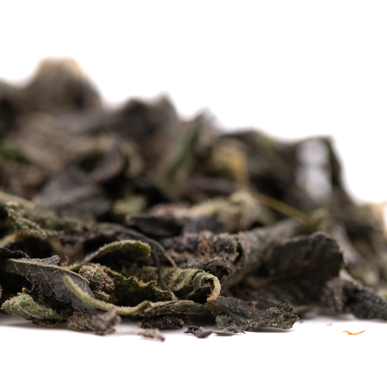 Dried dark green tea leaves with Girl Scout Cookies, THCA Trim, and Hemp Flower elements