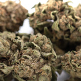Mature canal street runtz greenhouse thca flower with dense trichome-covered buds for physical relaxation