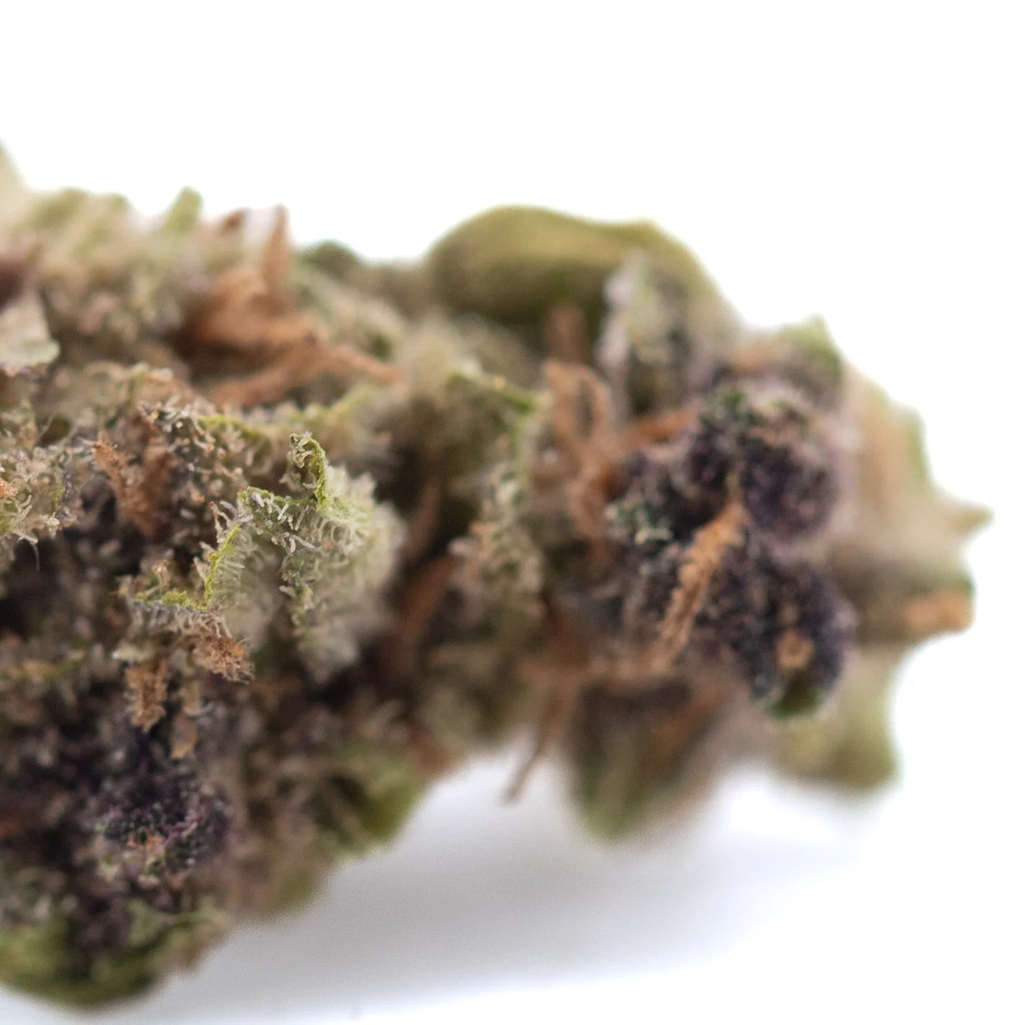 A dense green canal street runtz hemp flower thca smalls bud with white trichomes and brown pistils
