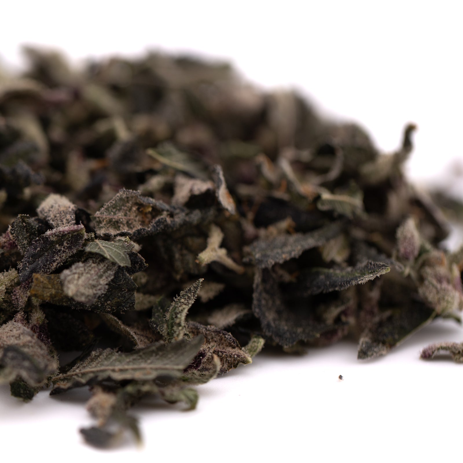 Pile of loose leaf dried herbs for Candy Mac Indoor Trim Wholesale 1LB with mac indoor trim and thca trim