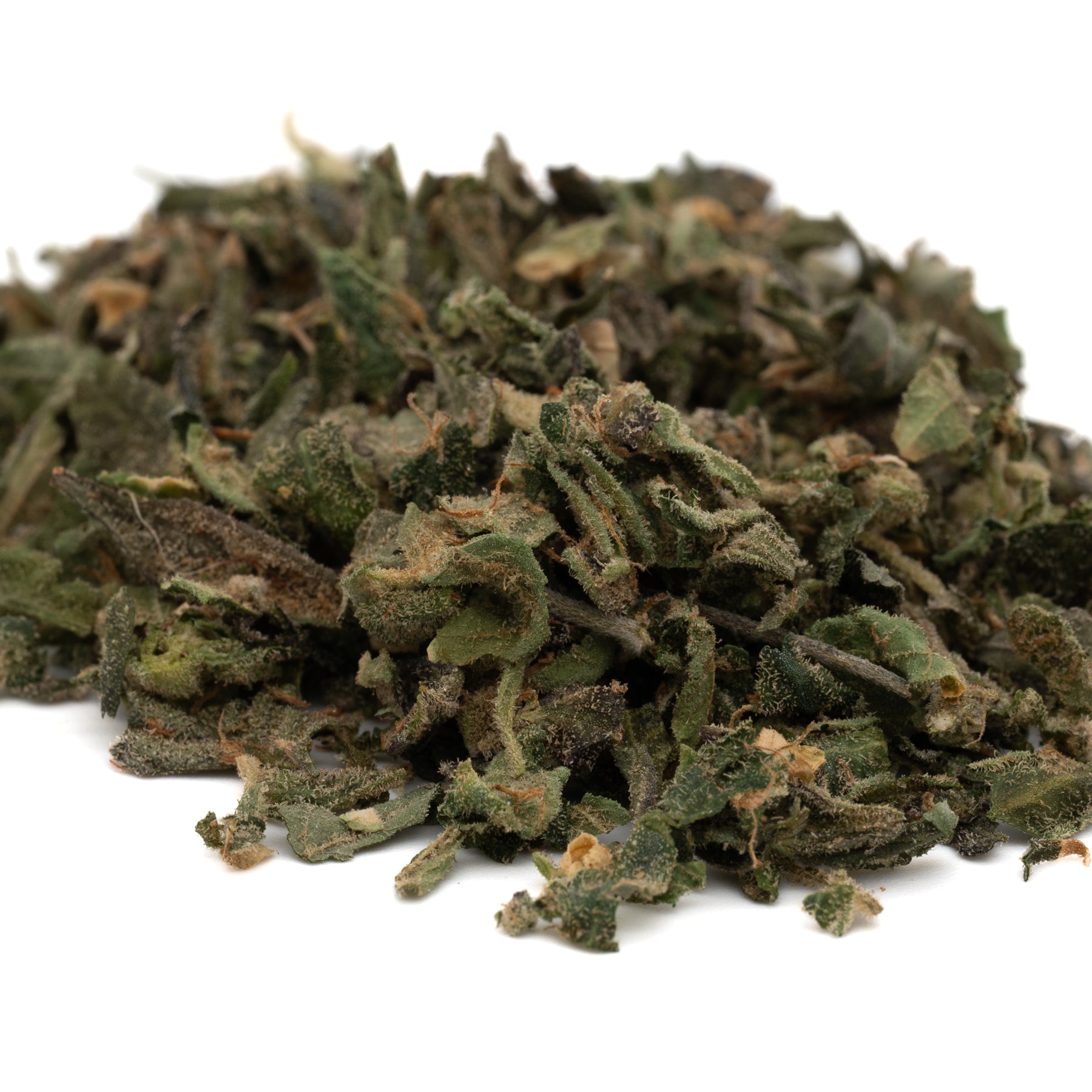 Pile of dried green herbs from Candy Mac THCa Indoor Trim Wholesale 1LB