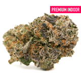 Vibrant cannabis bud with orange hairs and purple hues from Candy Rain Indoor THCa Flower