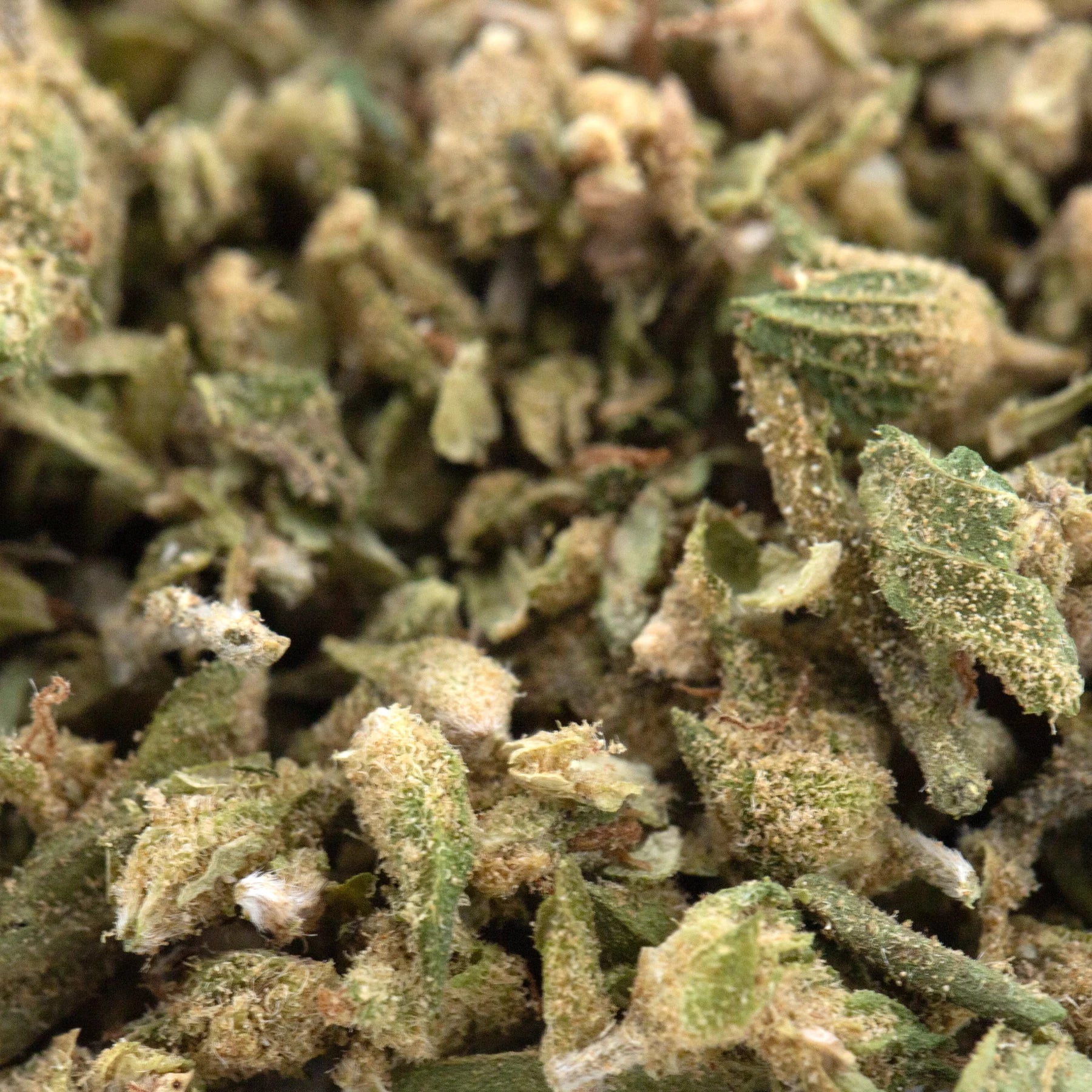 Cbg hemp flower trim with green and beige buds and a frosty textured surface in full-term hemp flower mix