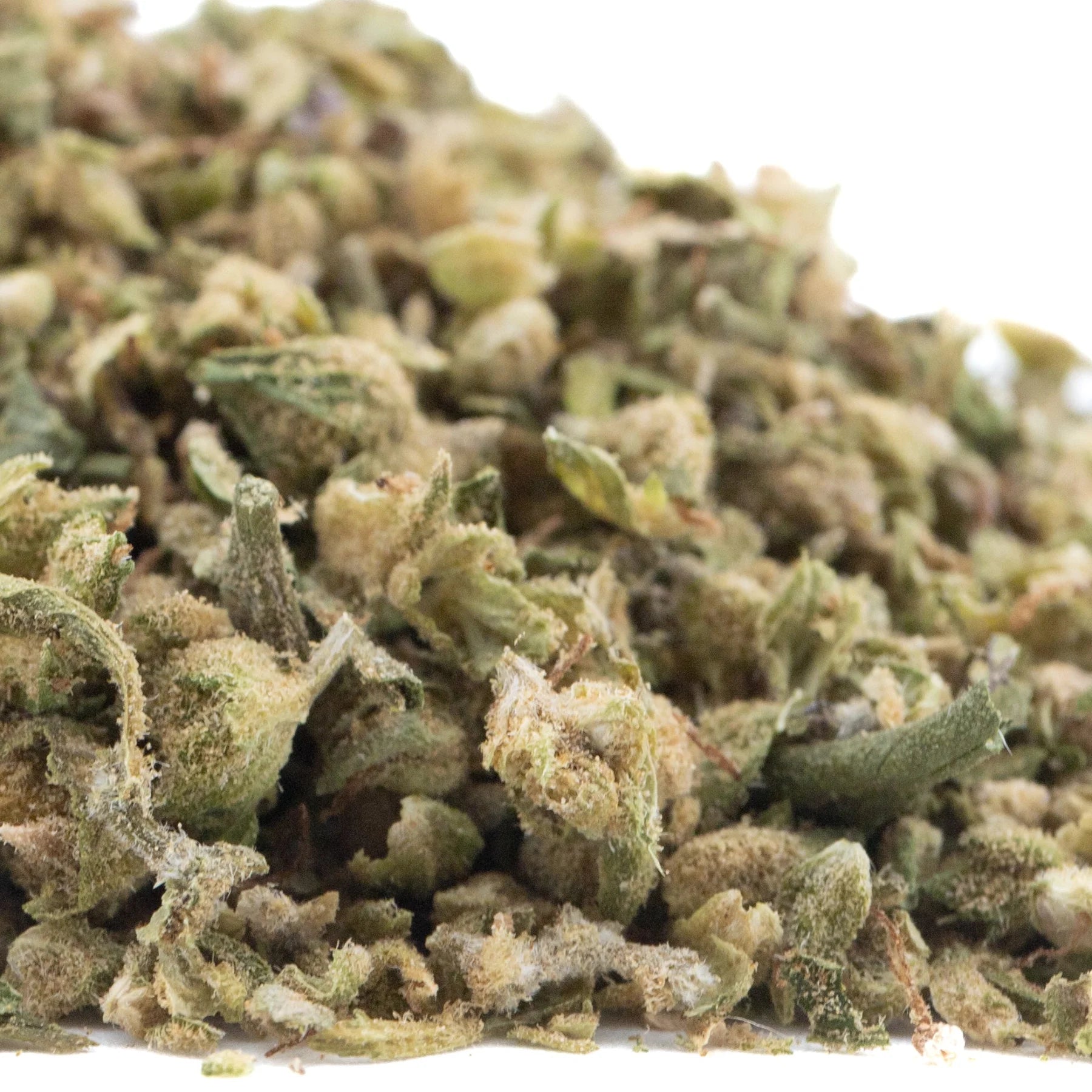 A pile of green and light brown cbg hemp flower buds covered in fine white trichomes from cbg 2 hemp flower trim full-term