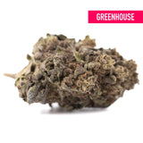 A dense cherry truffle greenhouse thca hemp flower bud with green brown hues and a rich terpene profile