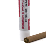A brown cylindrical chicken and waffles 32.05% thca blunt with a white and red label, ideal for kush mints fans