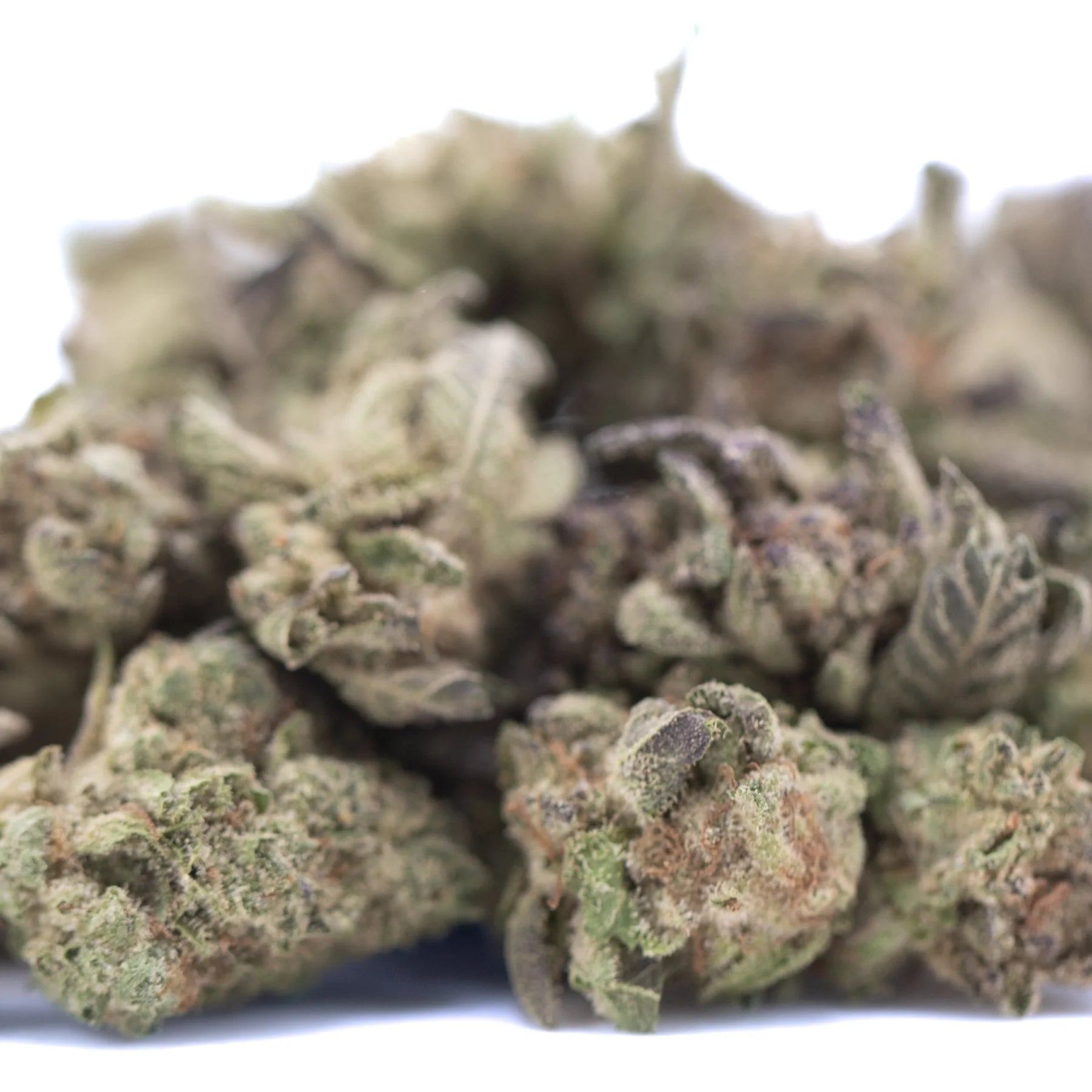 A dense green and purple tinged chicken and waffles thca greenhouse smalls bud with a textured surface