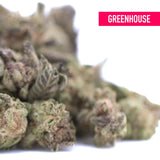 A dense green and purple-tinged chicken and waffles thca greenhouse smalls hemp flower resembling kush mints