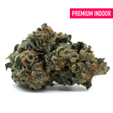 Dense trichome-covered Chunky Monkey Indoor THCa Flower with orange hairs and dark green leaves