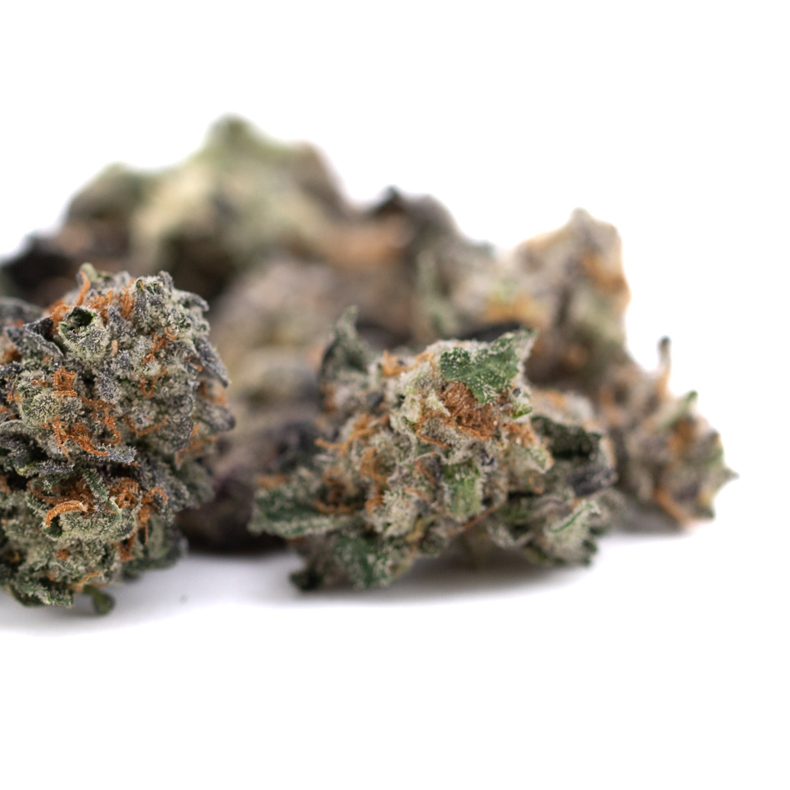 Close-up of Chunky Monkey Indoor THCa Flower Smalls with orange hairs and frosty look